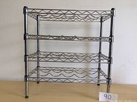 Front view of chrome metal wine rack with three tiers for wine bottle storage, holding up to 20 bottles.