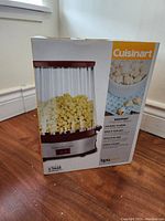 Photo of Cuisinart EasyPop popcorn maker box showing the product image on front with popcorn inside and key features.