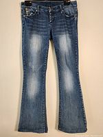 Full front view of Saductions women's denim pants, size 7, dark blue with faded areas on front thighs and knees, bootcut style