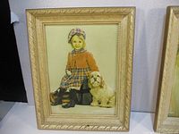 Full view of embossed art print showing a young girl sitting with a dog in a decorative frame
