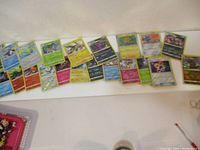 Fanned arrangement of multiple Pokemon cards showing front artwork and text, some with holographic foil.