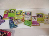 Spread of 20 Pokemon cards showing various cards, some holo, including Pikachu and other characters.