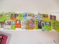 Several Pokemon cards laid out side by side showing a variety of Pokemon and types including Caterpie, Drowzee, Arcanine, and others.