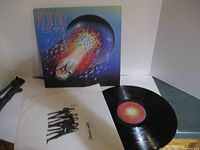 Journey Escape album cover with inner sleeve and vinyl LP visible.