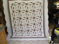 Full front view of the quilt showing overall double ring pattern and borders