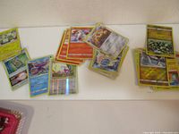 20 Pokemon holographic cards laid out in groups showing various characters and card designs.
