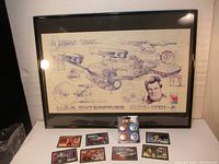 Framed Star Trek blueprint picture displayed with trading cards and 4-button set on a white surface.