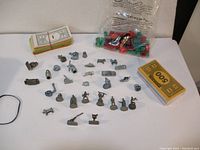 Overall view of Monopoly Star Wars figurines, Monopoly money, plastic houses and hotels in bag on white surface