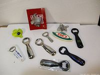 Lot of 10 assorted vintage and new bottle openers with various styles including wall mount and handheld openers