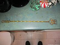 Full length view of the 19-inch vintage brass toasting fork showing twisted handle and decorative fork head.
