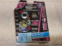 Front view of unopened Monster High Voltageous digital video recorder with camera packaging showing device graphics and branding.