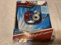 Front view of the sealed Spider-Man 2 2.1 digital camera package showing product and branding details