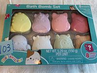 Front view of Squishmallows Bath Bomb Set box showing all 8 shaped bath bombs in various pastel colors with visible packaging and branding