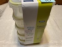Stacked five Komax Biokips airtight food containers wrapped in original packaging band