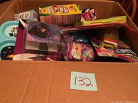 Overview of box contents showing multiple packaged items including markers, pet bowls, toy, mug kit
