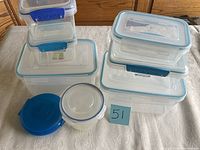First photo showing 10 plastic kitchen containers of various sizes and shapes on a table, mostly with blue lids. One small round container has a white lid, another small container has a blue lid.