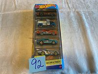 Front photo of 5 Hot Wheels cars in HW Circle Track packaging showing design and colors of each car