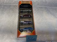Photo of unopened Matchbox car set with 5 cars inside showing front view of packaging and cars.