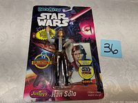Photo of Han Solo Star Wars Bend-Ems figurine in original packaging with bright galaxy background and product labels visible