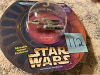 Close-up of die-cast metal Y-wing Starfighter Micro Machines in original packaging, showing movable action features and Star Wars branding.