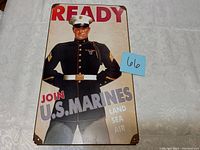 Front view of tin sign showing U.S. Marine in dress uniform with recruitment text.