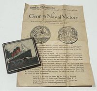 The medallion in its original box alongside the informational sheet describing the historical context.