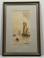 Framed watercolour painting showing full artwork and frame with ornate gold-tone. The scene includes several boats with detailed sails on calm water.