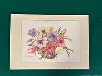 Full view of watercolour painting showing colorful flowers arranged in a small brown vase mounted on a cream mat board, signed by artist B. Palmer in bottom left.