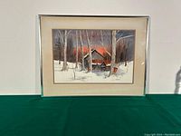 Framed watercolour showing full winter landscape scene with sugar bush building and trees