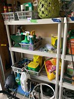 Full shelving unit with multiple garden care products, chemicals, and accessories organized in plastic baskets and bags
