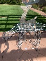 Reindeer with lower stance in beige wireframe with mixed white and green string lights DS angle