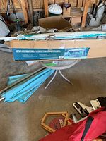 Full box of sun shelter gazebo with blue packaging label showing details and image of assembled model