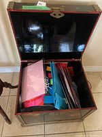 Open trunk showing assorted gift wrap and gift bags inside.