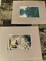 Two signed and numbered art prints by Henry Eng, mounted on beige mat boards, one with glass damage visible.