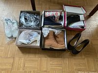 Photo showing all six pairs of ladies shoes and boots in various boxes and loose, sizes 10-11