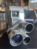 Front angle showing three turret lenses on the Keystone K27 CAPRI 8mm camera with visible textured finish and viewfinder.