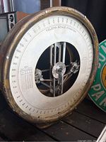 Front view of large circular Toledo Scale Company scale with visible dial and internal mechanism.