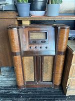 Front view of vintage Viking floor radio showing wooden cabinet, dial window, buttons, and speaker grille.
