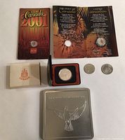 Full lot showing coins and keepsake set, original packaging, and display case