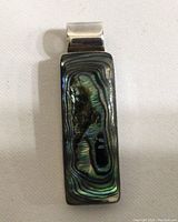 Front view of rectangular sterling silver and abalone shell pendant showing the iridescent swirl patterns.