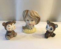 Photo of lady head planter flanked by two ceramic bear figurines showing overall condition and size relation.