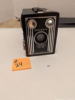 Front view of Kodak Brownie Target Six-20 box camera showing art deco front panel with two lenses and branding.
