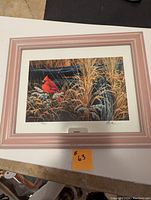 Framed print showing the artwork matted and behind glass with a pink and white mat and matching frame.