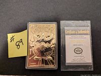Gold plated Togepi Pokemon card in protective case with Certificate of Authenticity visible beside it