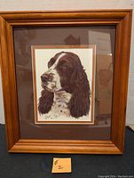 Full view of framed Spaniel portrait showing wooden frame and matting.