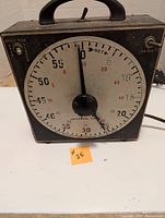 Front view of Gralab universal timer showing analog dial with large black knob and handle on top