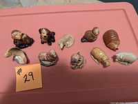 Overview of all 10 Wade animal figurines displayed on a red surface showing detailed animal forms and glaze finish.