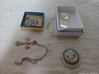 Overview photo showing all six items together including crosses, blessing stones, and St. Michael coin.