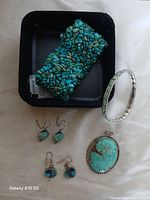Photo of the entire assortment showing cuff bracelet, two pairs of earrings, pendant and stretch bracelet all displayed on a white background.