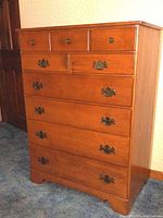 Front view of Ethan Allen tall dresser showing wood finish and drawer handles